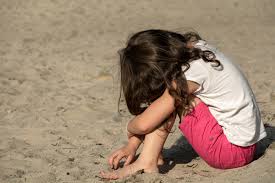 Little Girl Sitting On Beach